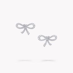 Stylish and feminine, these playful Tilda’s Bow mini diamond stud earrings in white gold scintillate softly, every day of the week. Entirely lifelike, the bow’s delicate silhouette has been carefully considered to appear as if it were freshly tied mere moment ago. The Tilda’s Bow collection features radiant diamond bows, presented upon petite pendants, stud earrings and delicate diamond rings, alongside expressive high jewellery interpretations featuring the iconic bow motif that has featured pr Delicate Diamond Rings, Graff Jewelry, Diamond Drop Pendant, Classic Diamond Ring, Diamond Drop Necklace, Pave Diamond Earrings, Diamond Bows, High Jewellery, Engagement Ring Shapes