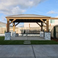 a gazebo in the middle of a yard with grass