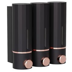 three black speakers with rose gold trim on them