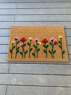 a door mat with flowers painted on it