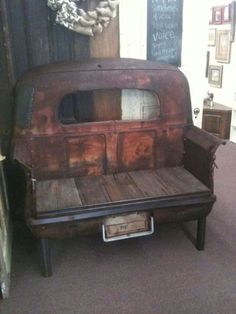 an old truck is sitting on display in a room with other furniture and decor around it