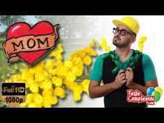 a man holding yellow flowers in front of a heart shaped sign with the word mom on it