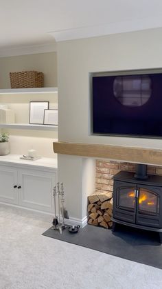 a living room with a fireplace and tv mounted on the wall above it's mantle