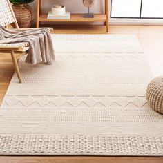 a living room with a white rug and chair