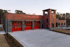 a fire station with red doors and windows