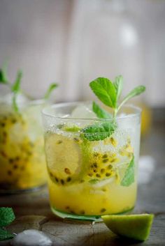 two glasses filled with lemonade and mint garnish