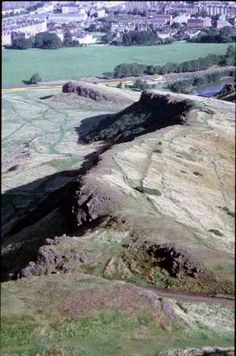 an aerial view of some hills and fields