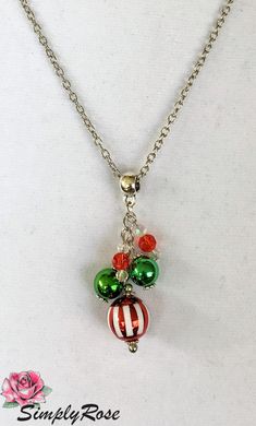 $24.95 This Christmas dangle necklace is just the touch of color for your festive occasion. The dangle measures about 2 inches and is hung on a 20 inch nickel free chain with a chain extender and nickel free lobster clasp. Silver Holiday Necklaces For Festive Occasion, Nickel-free Silver Necklaces For Christmas, Silver Holiday Necklace For Festive Occasion, Nickel-free Silver Necklace For Christmas, Silver Necklace For Christmas Celebration, Christmas Holiday Pendant Necklaces, Christmas Holiday Pendant Necklace, Green Necklace Christmas Gift, Gala Event