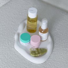 several different types of skin care products on a white tray