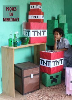 a young boy sitting on the floor in front of some cardboard blocks with words that say thi thi