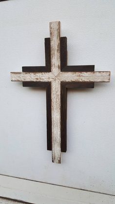 a wooden cross mounted to the side of a wall