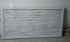 an old white wooden bed frame with no headboard or rails on the bottom and sides