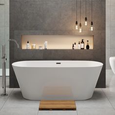 a white bath tub sitting in a bathroom next to a sink