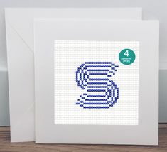 a greeting card with the letter c made out of lego blocks and blue thread on it