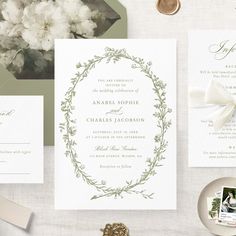 the wedding stationery is laid out on a table