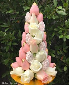 there is a cake made to look like a tower with flowers on the top and sides