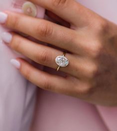 a woman's hand with a diamond ring on her finger