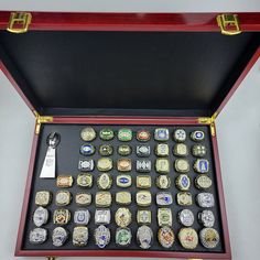 a red case with many different types of badges in it