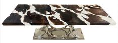 an animal print table top on a chrome base