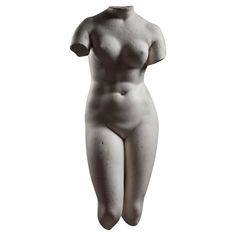 a white female statue is standing in front of a white background and has her hands behind her head