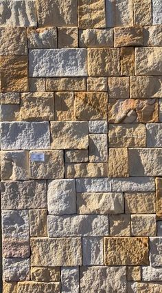 a stone wall that is made out of different types of rocks