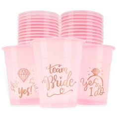 pink plastic cups with gold foil lettering on the side and team bride to be written on them