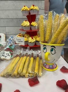 a table topped with cupcakes and other treats