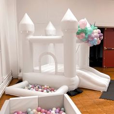 an inflatable castle with balloons is on the floor