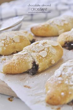 several croissants with powdered sugar on top