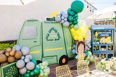 there is a garbage truck decorated with balloons