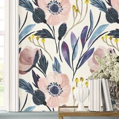 the wallpaper is decorated with pink flowers and blue leaves, along with white vases