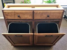 two black chairs are sitting in front of a wooden cabinet with doors and drawers on it