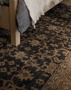 a bedroom with a bed and rugs on the floor