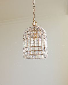 a chandelier hanging from the ceiling in a room with white walls and flooring