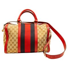 Gucci Boston bag with a shoulder strap. The bag is made of GG brown/beige canvas and red leather trim. The bag features a navy/red Gucci signature race strap. The hardware is gold toned. The interior is lined with beige fabric, and next to the major compartment it features three side pockets of which one has a zipper. The bag was used occasionally and it is in good condition, the original leather pull zipper is replaced with a universal gold toned metal pull zipper, please see the detailed pictu Burberry Bucket Bag, Gucci Boston Bag, Gucci Runway, Louis Vuitton Neverfull Pm, Burberry Classic, Gucci Brand, Gucci Outfits, Gucci Tote, Beige Fabric