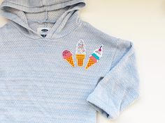 a blue hoodie with ice cream cones on it