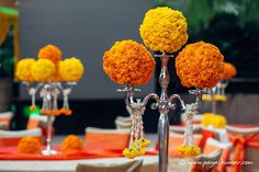 the centerpieces are adorned with orange and yellow flowers