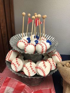 cake pops with baseballs on them sitting in a bowl