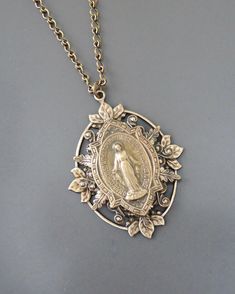 Our vintage inspired Virgin Mary necklace is a beautiful reminder of your devotion to Our Lady. We particularly love the way the botanical garden encircling her evokes her esteemed position as the new Eve. This necklace is a statement piece you will enjoy for years to come. 18" brass link chain solid brass medal Mother Mary Necklace, Miraculous Medal Necklace, Grandmother Jewelry, Mary Necklace, Virgin Mary Necklace, Accessory Jewelry, Bainbridge Island, Catholic Jewelry, Jewelry Hair