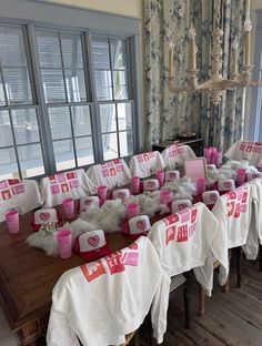 the tables are covered with pink and white tablecloths