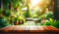 an empty wooden table in the middle of a garden with sunlight shining through the trees