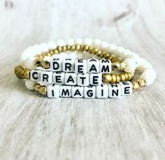 "Word Affirmation bracelet Sets accented with Letter Beads Dream Create Imagine Materials: multi size cream white glass beads, acrylic letter beads 3 Piece Set Stackable Bracelet sets Stretch Bracelet approximately 6.75\" length Made of very resilient clear cording Please visit my shop for more listings at www.fernhomeandfashion.etsy.com" Inspirational White Bracelet With 8mm Beads, Inspirational White Name Bracelet With Round Beads, Inspirational White Bracelet Jewelry, Inspirational White Name Bracelet With Letter Beads, Inspirational White Round Bead Jewelry, Inspirational Handmade White Stretch Bracelet, White Inspirational Stretch Bracelet With 8mm Beads, Inspirational Adjustable White Name Bracelet, White Spiritual Stretch Bracelet With Letter Beads