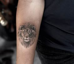 a man with a lion tattoo on his arm