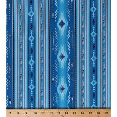 a blue and white striped fabric with an intricate design on it's side, next to a ruler