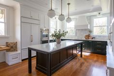 a large kitchen with an island in the middle