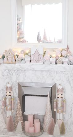 a fireplace decorated with pink and gold christmas decorations, candles and ornaments on the mantle