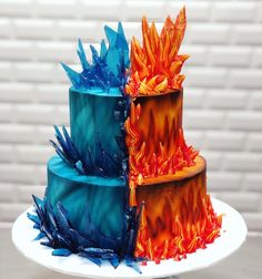 a three tiered cake with blue and orange frosting