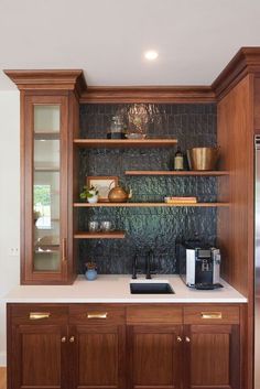 a kitchen with wooden cabinets and white counter tops