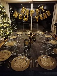 a table set up for a new year's eve celebration with plates and silverware