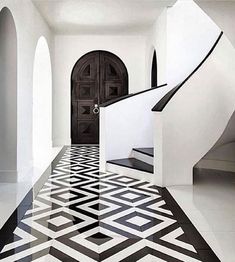 an artistic black and white hallway with stairs